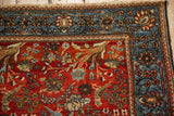 Detailed corner of an antique Farahan Sarouk showing the hand-knotted pile and sapphire blue floral border.