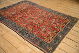 Angled perspective of a Farahan Sarouk rug displaying its repeating forest design with perched birds.