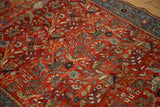 Intricate forest scene with perched birds and floral vines on a gem-toned Farahan Sarouk rug.
