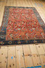 Perspective view of an antique Farahan Sarouk rug highlighting its repeating forest scene design.