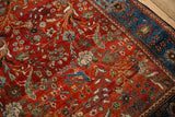 Perched birds and floral bouquets in vivid gem-tones on an antique Farahan Sarouk Persian rug.