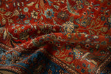 Rippled texture of an antique Farahan Sarouk rug highlighting its gem-toned floral and bird pattern.