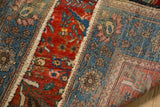 The hand-knotted foundation of the antique rug shown alongside its vibrant red pile.