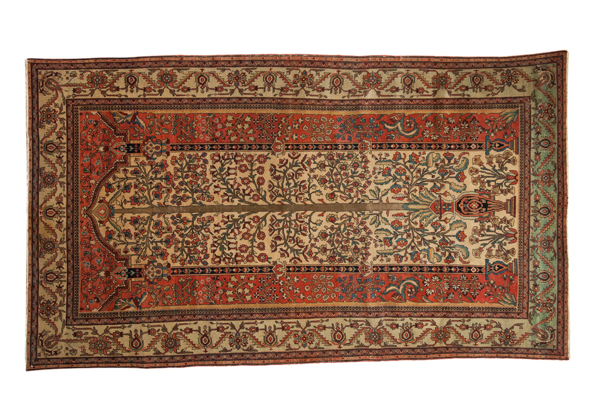 Antique Fereghan carpet with a Tree of Life design on an ivory field, framed by wide terracotta and green floral borders.