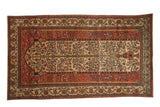 Antique Fereghan carpet with a Tree of Life design on an ivory field, framed by wide terracotta and green floral borders.