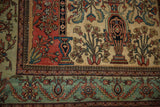Corner of an antique Fereghan carpet with a tiered vase motif and jade green floral border.