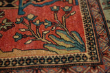 Detail of antique Fereghan carpet showing low pile, green abrash, and floral motifs.