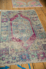 Distressed Oushak rug detail: worn pile, knot heads, pale royal blue, eggplant, mint colors.