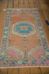 Distressed vintage Oushak runner with blue roundel medallion and germinating trees.