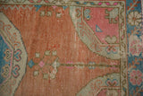 Distressed Oushak rug texture, highlighting sandalwood, pink, and sky blue hues with softened pile.