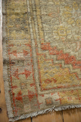 Muted saffron yellow and terracotta pile texture on the distressed vintage Oushak rug.