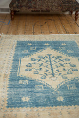 Distressed denim blue field with ivory stepped outlining and starburst motifs on Oushak rug.