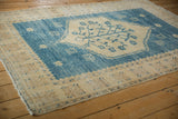 Vintage Distressed Oushak rug corner showing geometric border and visible side cord selvage.