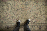 Low pile texture of a distressed Kayseri carpet with dusty rose and silver floral patterns.