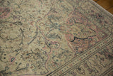 Distressed low-pile texture revealing floral motifs in dusty rose on a vintage Kayseri carpet.