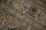 Detail of a small spot on the worn floral pile of a distressed Kayseri carpet.