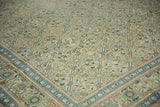 Corner view of the distressed Kayseri's meandering vine border and trellis field pattern.