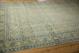 Angled view of a distressed Kayseri rug's trellis pattern in soft ivory, blue, and beige.
