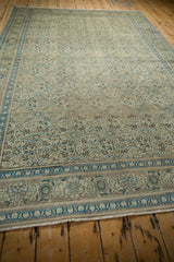 Angled perspective of a vintage Kayseri carpet highlighting its repeating trellis pattern and border.
