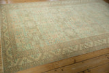 Full perspective view of a vintage Sparta carpet's repeating geometric shield motif.