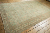 Full length view of a distressed Turkish Sparta carpet's faded geometric pattern and low pile.