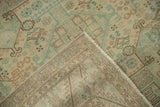 A folded corner of the vintage Sparta carpet reveals its hand-knotted back and machine-bound edge.