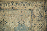 Repeating floral panel designs on the worn, low pile of a vintage Turkish Kayseri corner.