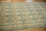 Angled view of a vintage Kayseri carpet showing its time-softened texture and panel design.