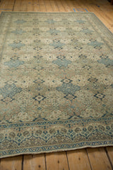 Low angle view across the distressed pile and repeating panel design of a vintage Kayseri carpet.