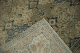 Folded corner of a vintage Kayseri carpet showing its hand-knotted back and machine-bound edge.