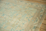 Serrated leaf and serpent borders framing the geometric shield medallion field on a distressed Sparta carpet.