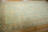 Angled view of a distressed Sparta carpet highlighting its allover geometric pattern and time-softened color.
