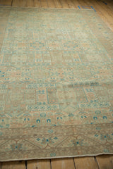 Perspective view down the length of a distressed Sparta carpet showing its faded, geometric field.