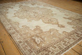 Long angle view of the distressed vintage Kars rug showcasing its large shield-like medallion.