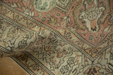 Distressed vintage Sparta carpet texture showing rose and ivory interconnected vine motifs with faint foundation.