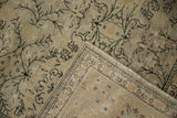 Folded Distressed Sivas carpet reveals diamond vines, palmette border, and soft low pile texture.