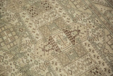 Angled detail of a vintage Sparta carpet's low-pile texture and geometric shield motifs.