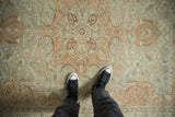 Overhead view showing the distressed, low-pile texture and floral medallion of a vintage Kayseri carpet.
