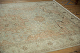 Angled perspective on a vintage Kayseri carpet, highlighting the soft, worn pile and scrolling border.
