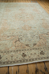 Low perspective along the sprawling vine and fern patterns of a distressed Kayseri carpet.