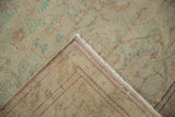 The hand-knotted foundation and machine-bound edge of a vintage distressed Turkish Kayseri carpet.
