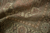 Softly draped vintage Sparta rug showing the distressed, low-pile texture and muted colors.