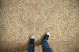 Overhead view highlighting the worn texture and sprawling floral design of a vintage Sparta carpet.