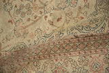 Scrolled vines and floral border details on the low, hand-knotted pile of a vintage Sparta rug.
