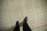 Close view of the worn texture and scrolling floral vines on a distressed Kayseri carpet.