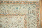 Corner detail of a distressed Kayseri carpet with floral borders in sandalwood and silver-blue.
