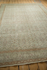 Angled perspective showing the low-pile texture of a distressed Kayseri carpet with scrolling floral vines.