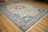 Kayseri carpet's curvilinear floral arabesque border with sapphire blue, ivory, and terracotta.