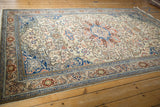 Kayseri carpet border with sapphire blue floral palmettes, alongside ivory field vines.