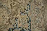 Evenly worn pile showing the scrolling vine pattern and border of a vintage Kayseri carpet.